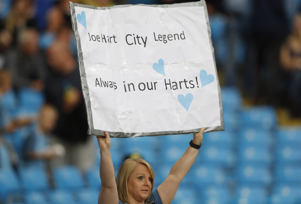  A Manchester City fan holds up a banner for Joe Hart ahead of kick-off