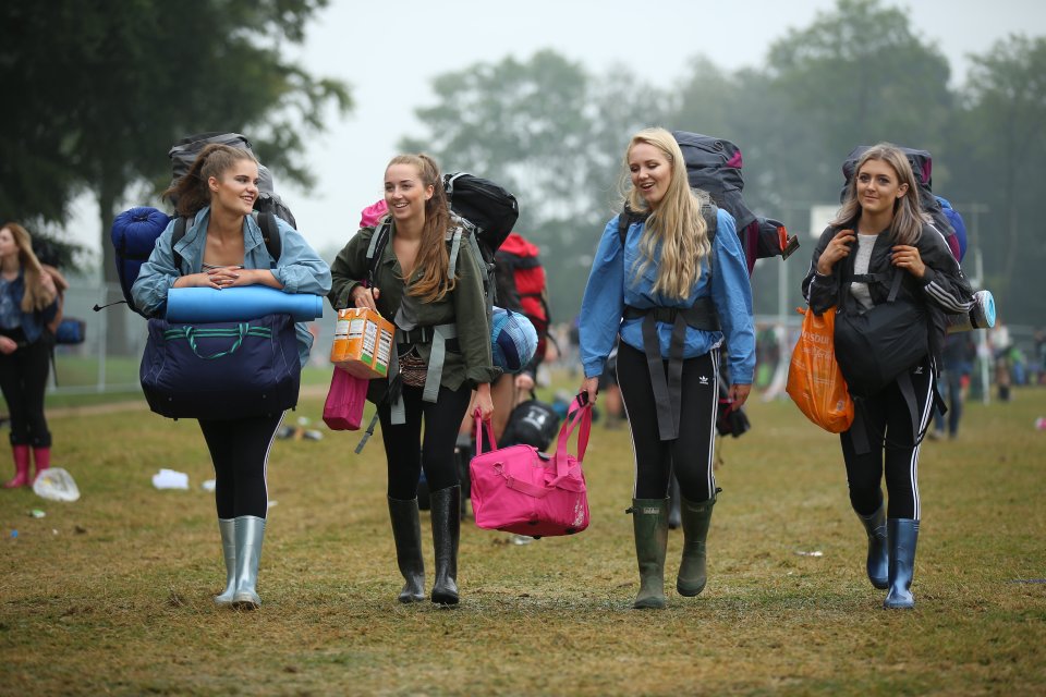  A group of girls make their way through the site of a damp Leeds Festival today as thousands of people are expected to arrive