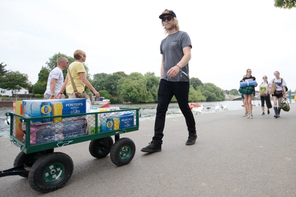  A Reading Festival-goer is well stocked up as he makes his way to the campsite today