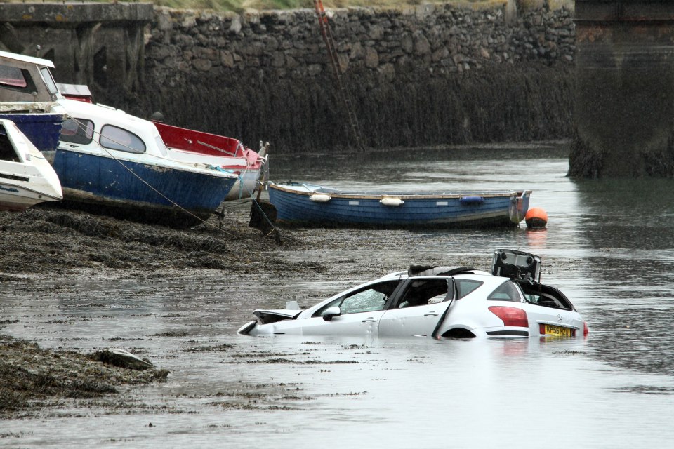 The couple were pulled from the car which officers have said was upside down in the water at one stage