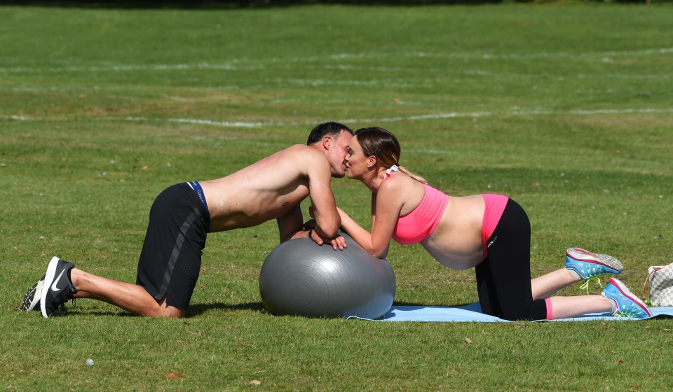  The soon-to-be parents looked happy and in love while they worked out in the sun