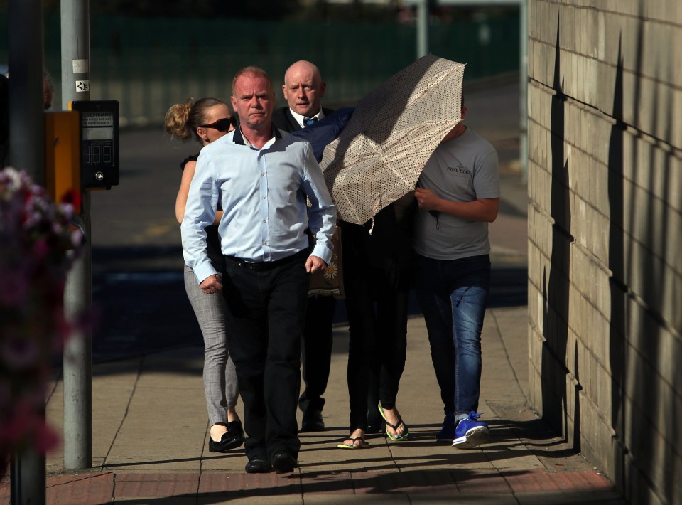  Members of their family appeared to try and shelter the pair under umbrellas