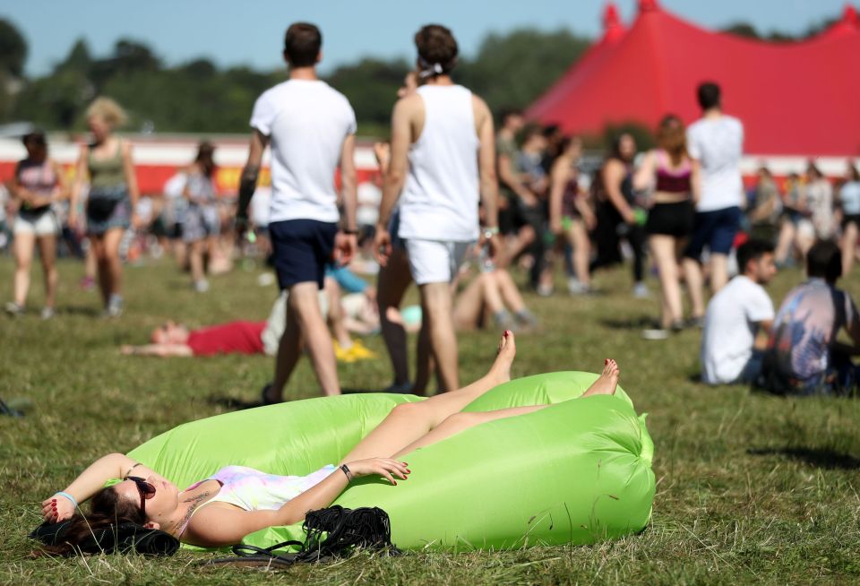  A woman sunbathes in at Reading Festival 2016 as temperatures soar