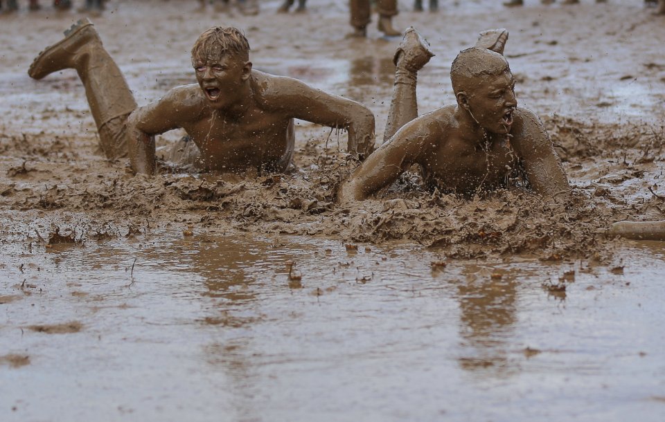  Two men launch themselves into the mud at Leeds Festival 2016 near Wetherby this afternoon