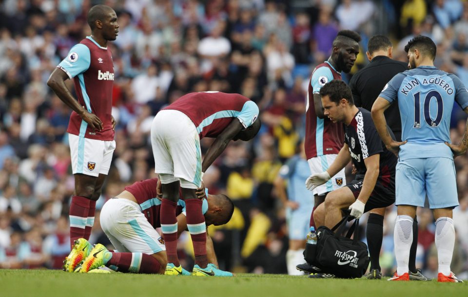  West Ham defender Reid is left on the floor after being elbowed by Aguero