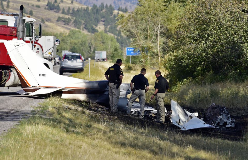  Missoula County sheriff's deputies look at the wreckage of the crash near Interstate 90, Texas