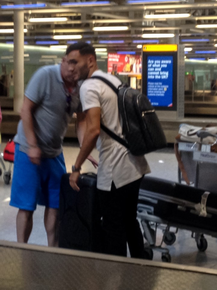  Lucas Perez picks up his bags after landing at Heathrow Airport