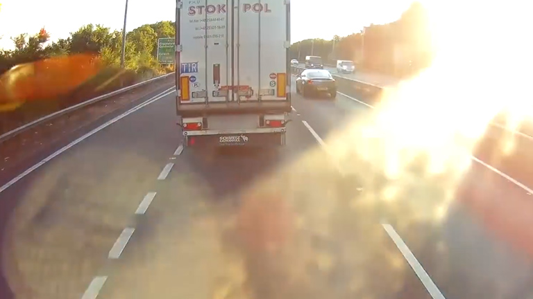  Other cars can be seen passing the lorry as its rear end swings dangerously from side-to-side