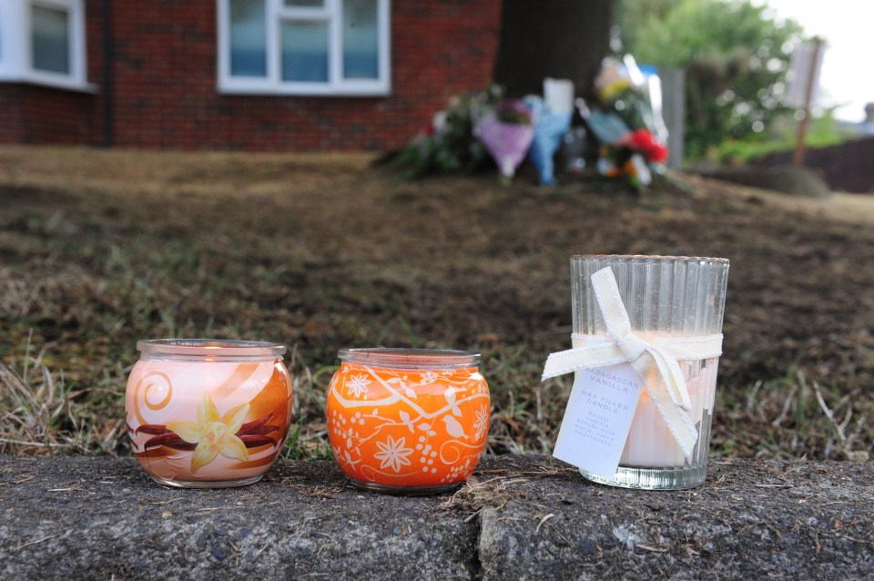  Candles line the pavement which was mounted by the fleeing stolen car