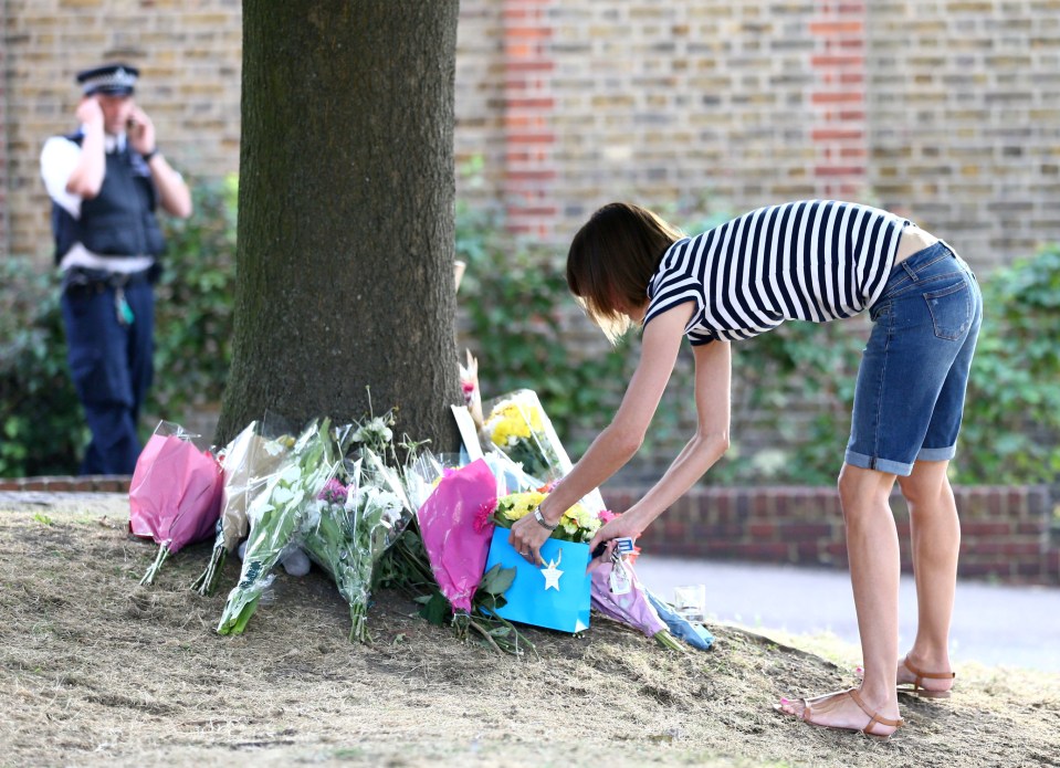  Dozens left notes, flowers and soft toys at the location where the mother and her nephew were killed yesterday