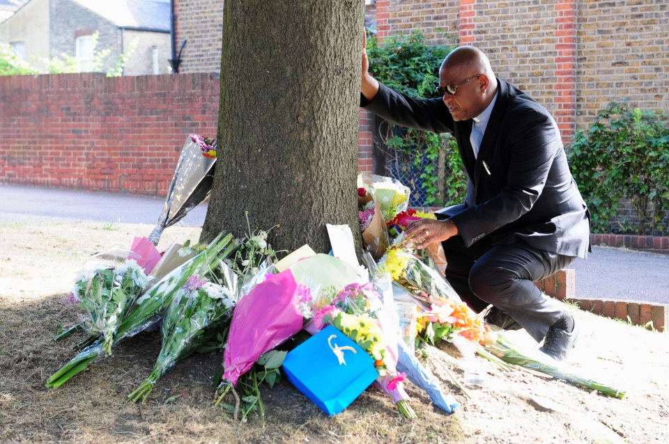  He was among the dozens of mourners who lay flowers at the site of the deaths