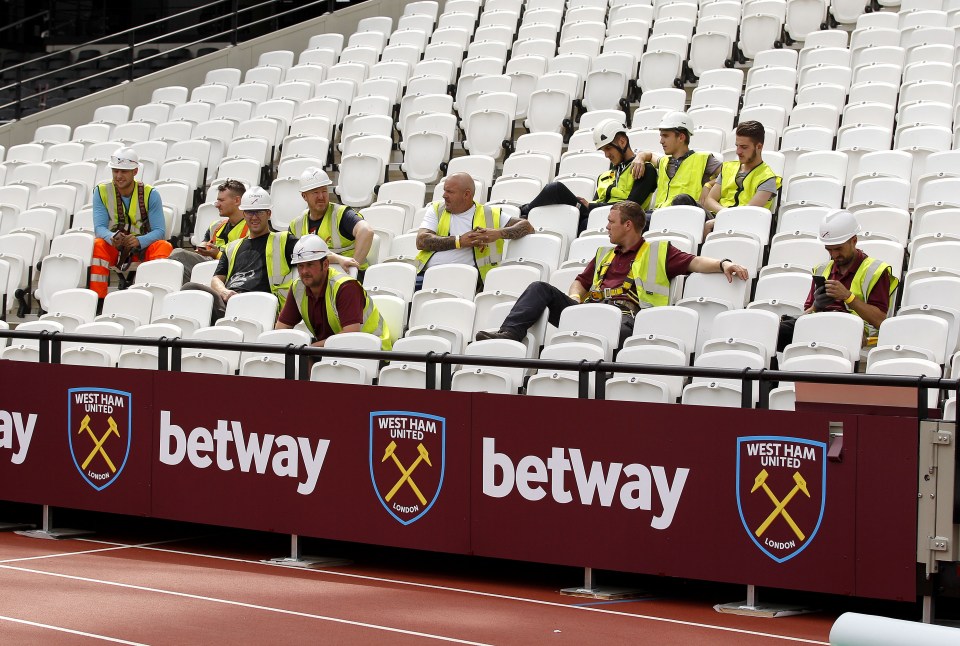  Workers take a break to watch West Ham in training