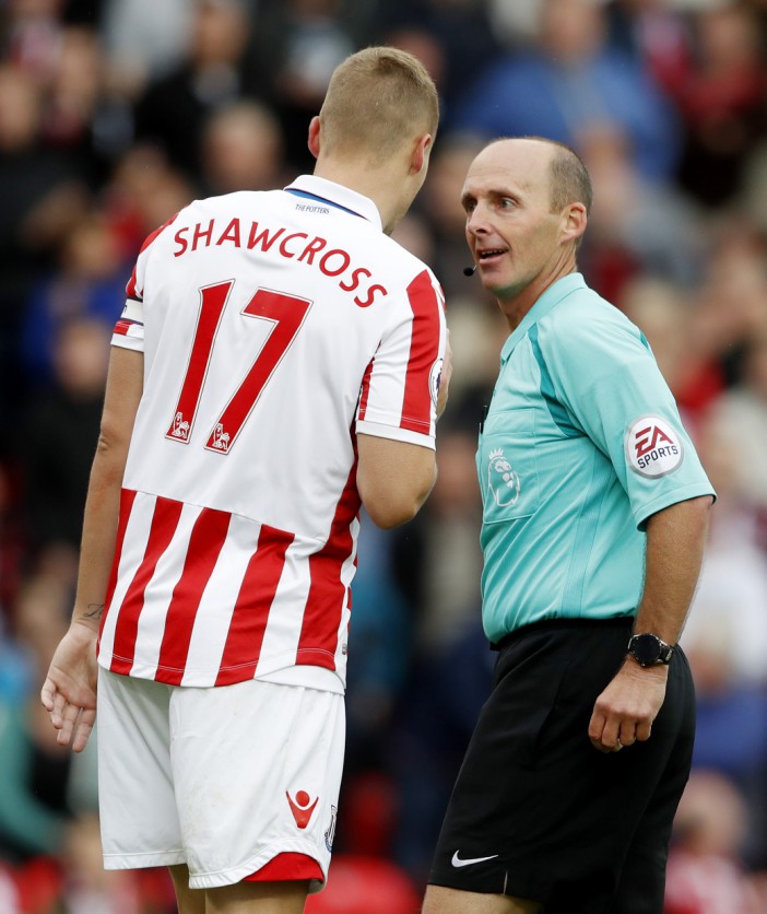  Ryan Shawcross is given a talking-to by referee Mike Dean against Manchester City