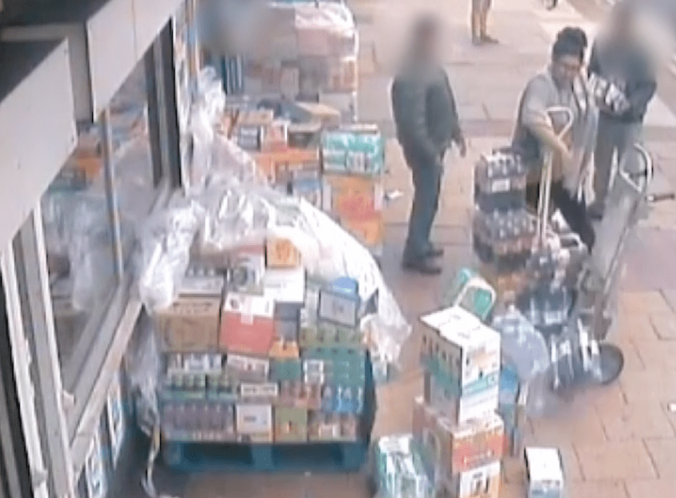  CCTV footage of the woman hurling stock items onto the floor and into the road as staff try to stand their ground