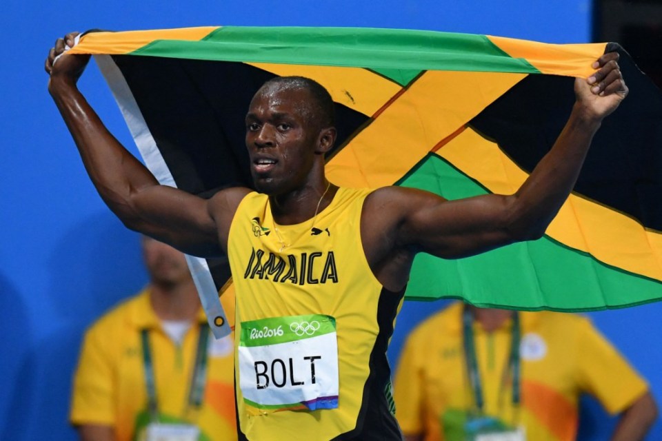 Jamaica's Usain Bolt celebrates holding Jamaica's flag after winning the Men's 200m Final during the athletics event at the Rio 2016 Olympic Games at the Olympic Stadium in Rio de Janeiro on August 18, 2016. / AFP PHOTO / Yuri CORTEZYURI CORTEZ/AFP/Getty Images