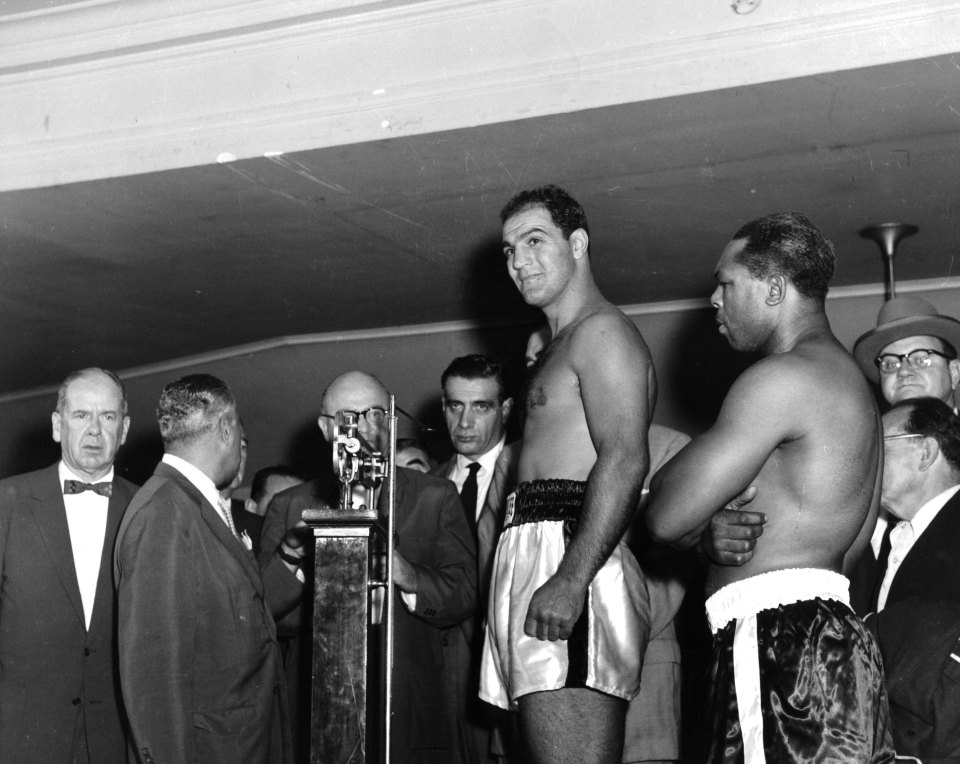 BRONX - SEPTEMBER 21,1955: Rocky Marciano weighs-in as Archie Moore looks on before the fight at Yankee Stadium, on September 21,1955 in Bronx, New York. Rocky Marciano won the World Heavyweight Title by a KO 9. (Photo by: The Ring Magazine/Getty Images)