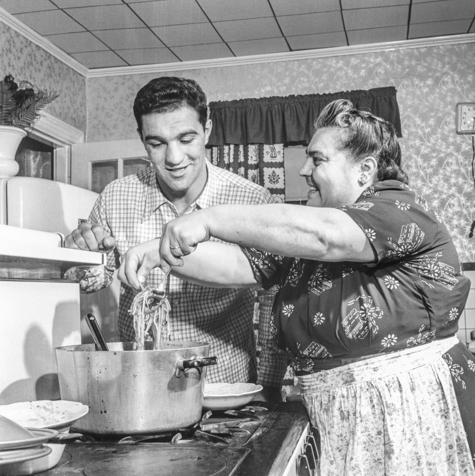 BROCKTON, MA - JULY 1: Rocky Marciano with his mother in the kitchen of the house he grew up on July 1, 1953 in Brockton, Massachusetts. (Photo by The Stanley Weston Archive/Getty Images)