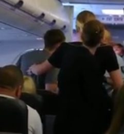  The man, who had just been sick and become aggressive on a flight, seen here being helped up by air stewards