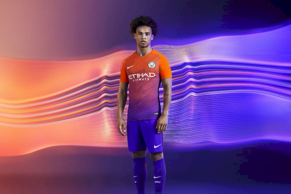  Leroy Sane poses in the new orange and violet Manchester City third kit