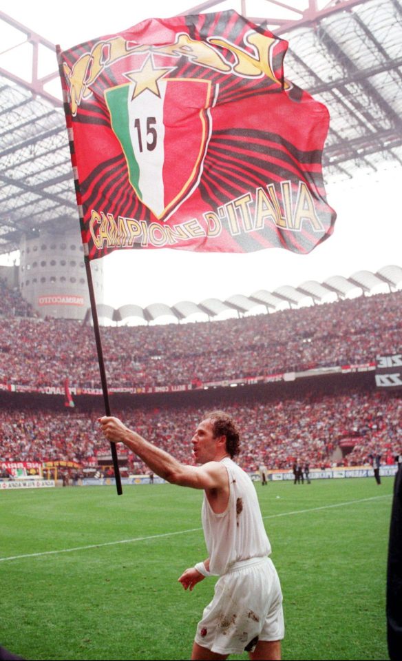  Franco Baresi holds a flag celebrating Milan's 15th league title — won in 1996