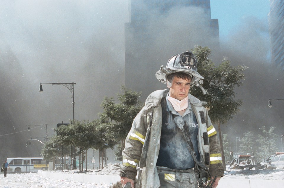 An unidentified New York City firefighter walks away from Ground Zero