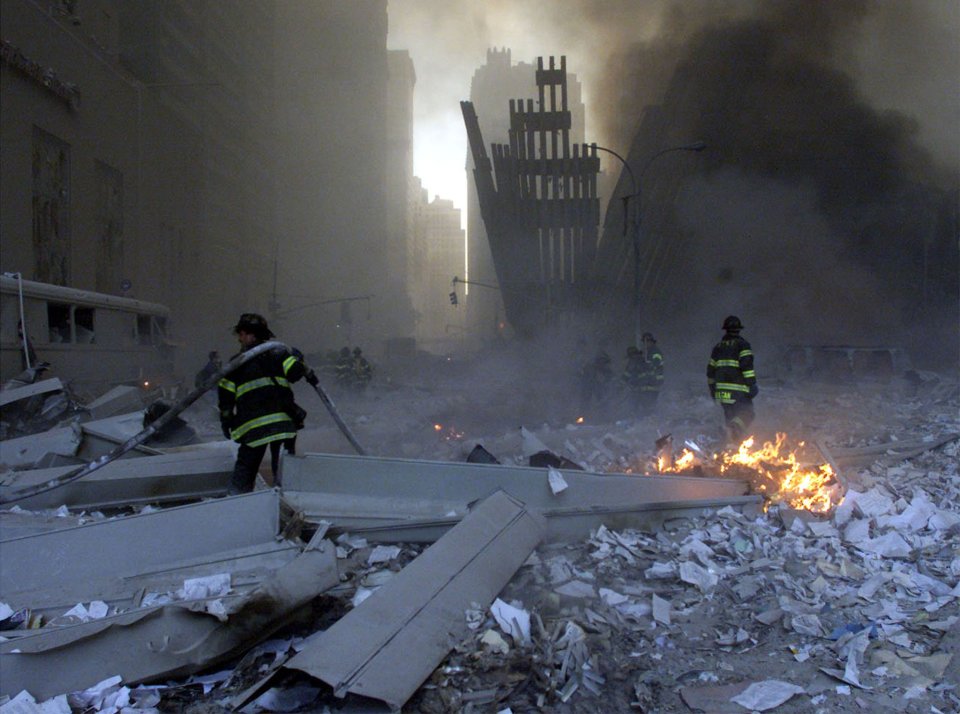 Firemen work around the World Trade Center after both towers collapsed