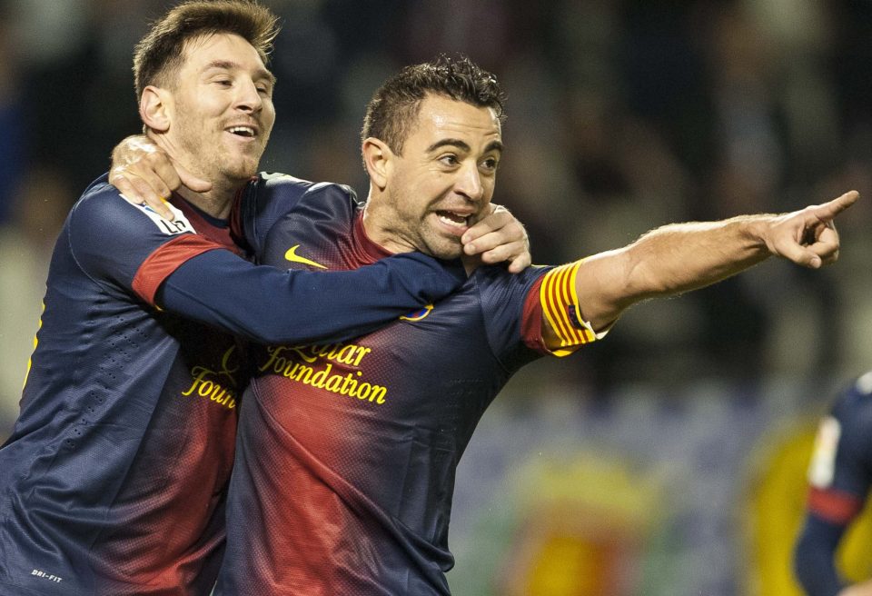 Xavi Hernandez of FC Barcelona celebrates with his teammate Lionel Messi