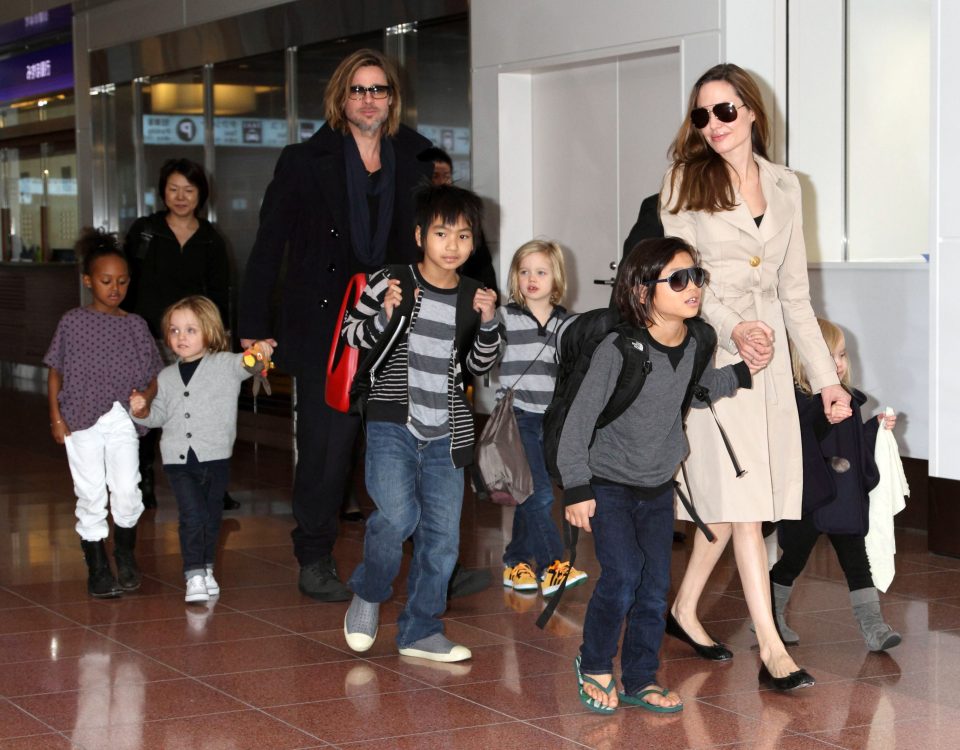  Angelina Jolie and Brad Pitt round up the troops at the airport