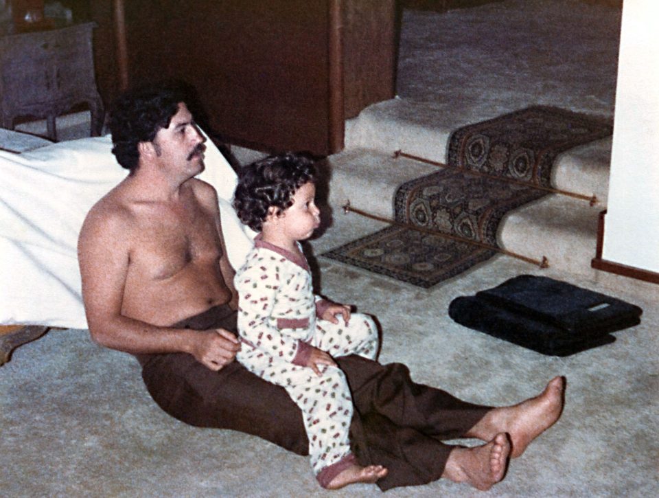  Family snap of Escobar, who was earning £322million a week, watching TV with his son Sebastian