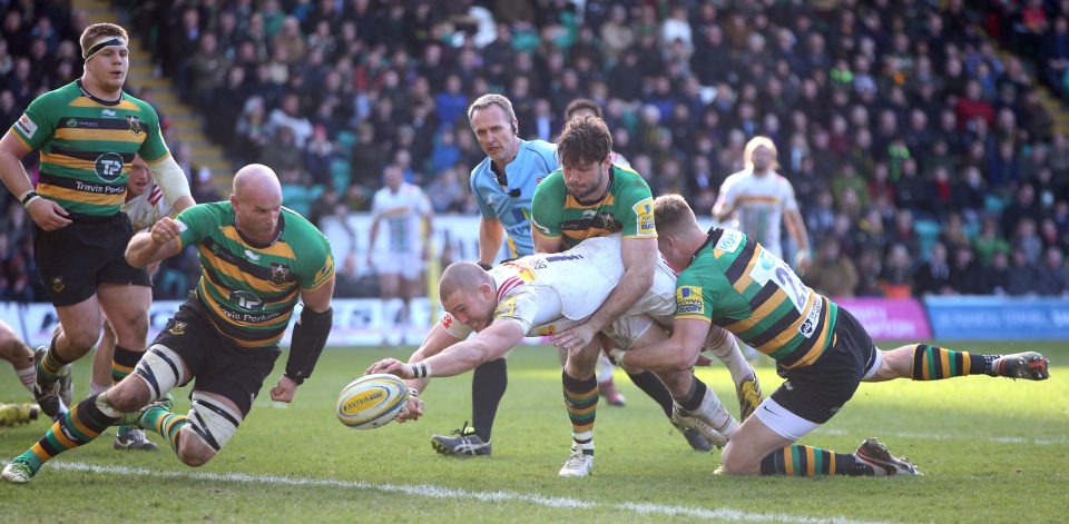 Mike Brown is just denied a Harlequins try as as Northampton duo Ben Foden and Harry Mallinder tackle him