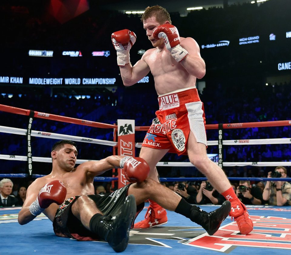 Alvarez stands over Khan after delivering a knockout punch during the sixth round