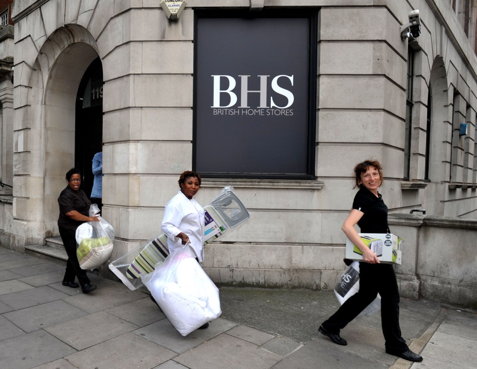  BHS staff carry goods that they purchased with discount as the high street chain closed for good