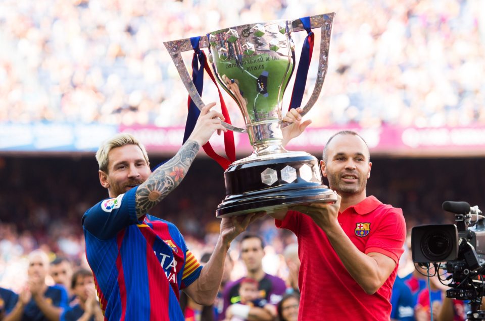 Lionel Messi (L) and Andres Iniesta (R) of FC Barcelona lift up the Spanish La Liga 2015-2016