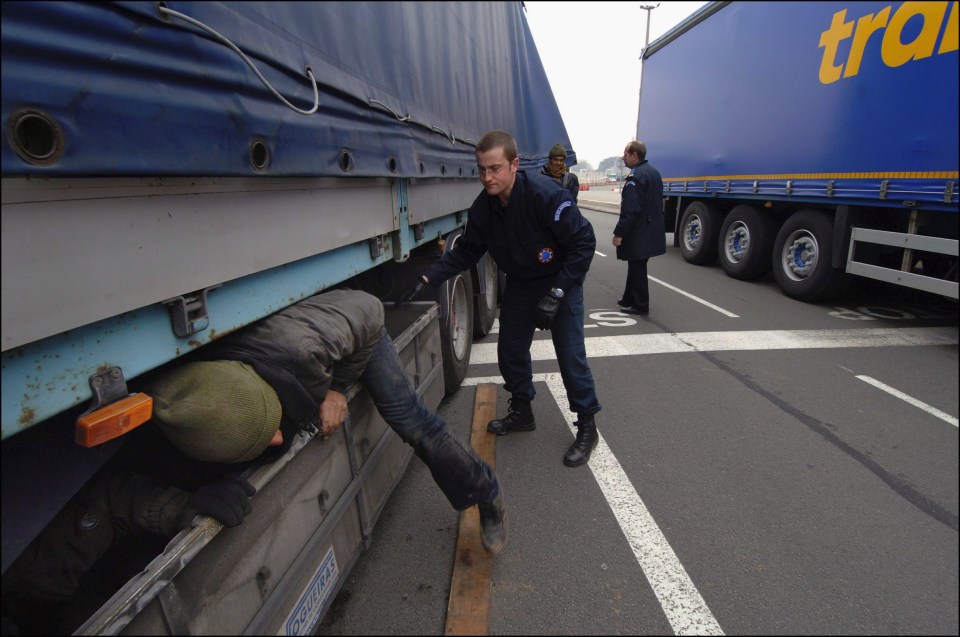  The Police frontier (PAF) arresting migrants who smuggled themselves into a lorry waiting to cross to the UK