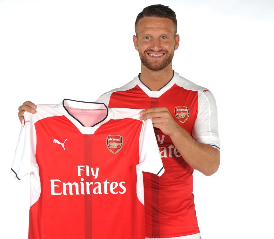  Shkodran Mustafi holds up a shirt that will have the number 20 on the back of