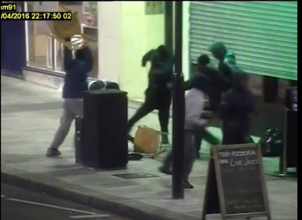  CCTV footage released by police shows the gang attack a man with chairs, leaving him unconscious on a pavement