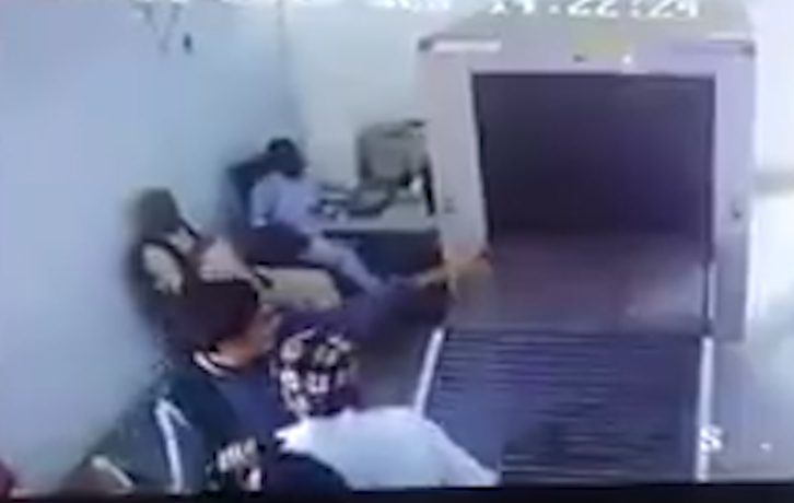  Outraged security guard runs to the novice traveller after he goes through X Ray machine