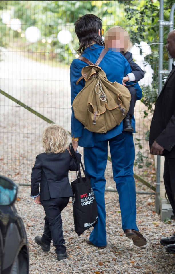 The musician kept his children close as he headed into the church where he had married their mother in 2012