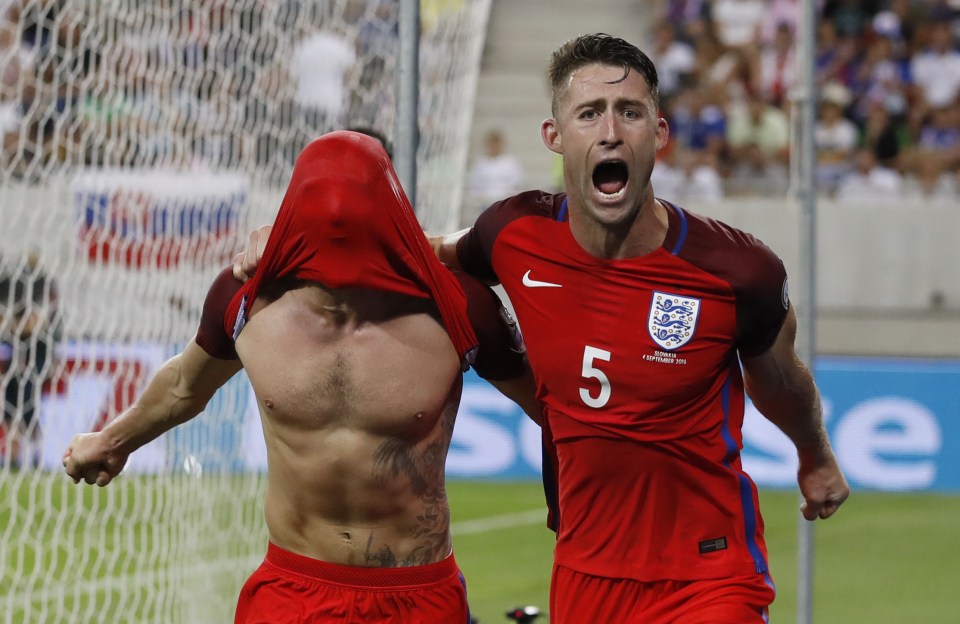  Adam Lallana is joined by Gary Cahill as England celebrate their late winner against Slovakia