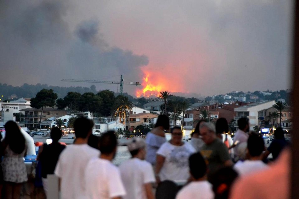  Locals stare at the fires in the hillsides