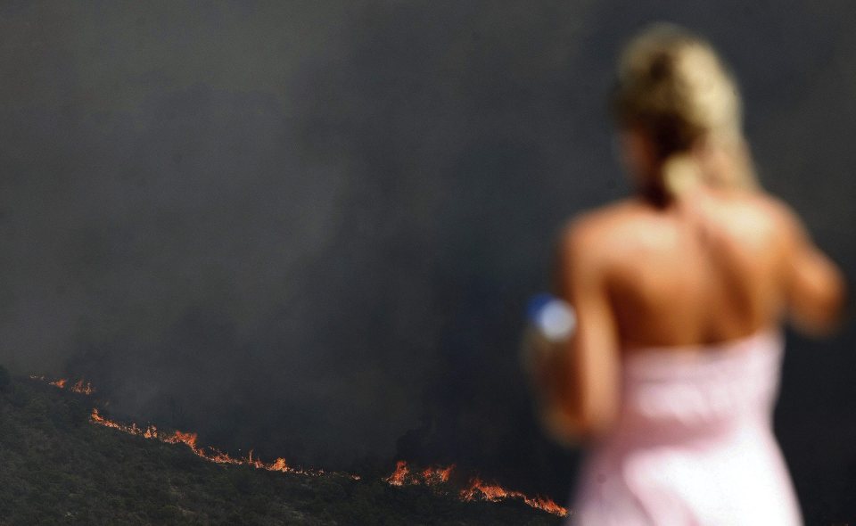  A woman stares at the encroaching flames