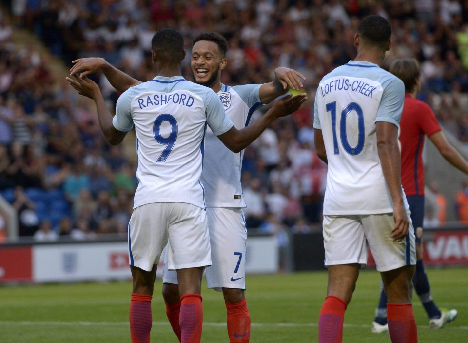  Rashford is surrounded by his teammates as he bagged a hat-trick on U21 debut