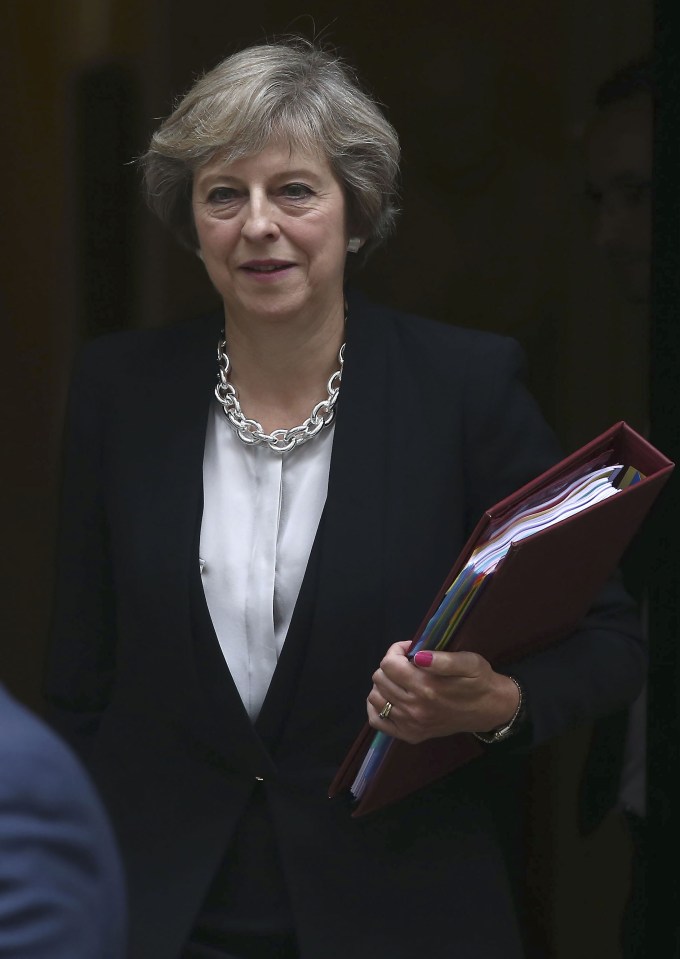 Theresa May pictured leaving Downing Street this morning in her chain