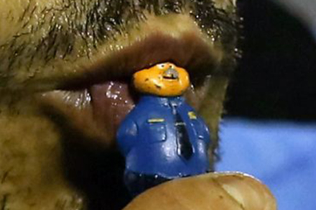  A close-up of he toy being kissed by Suarez