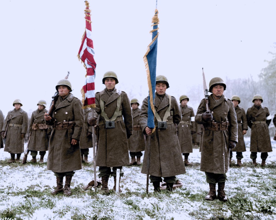  442nd Rct Color Bearers And Guards of the Japanese-American division stand to attention in the town of Bruyeres area in France in November 1944