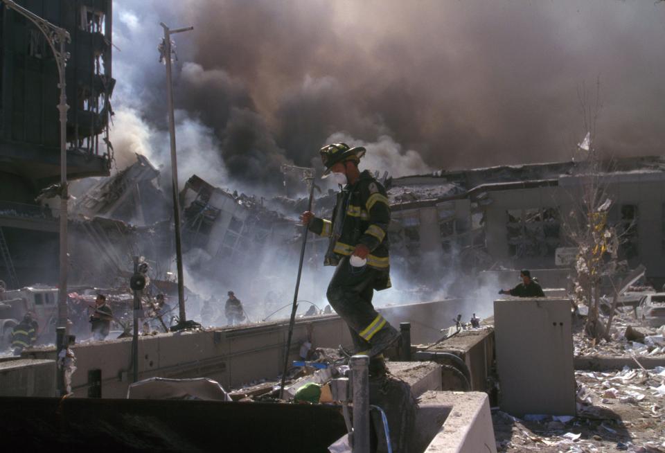  A firefighter walks through the smoking wreckage of the devastating terror attack