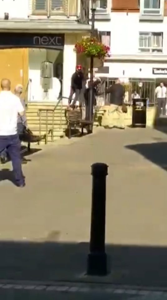  A man in a shirt and tie chased the men from the entrance to the shop