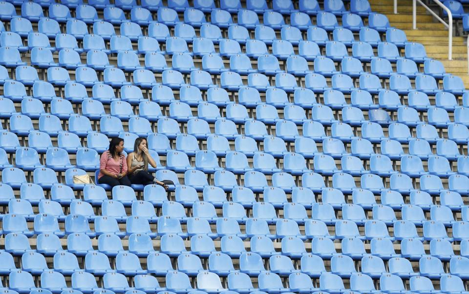  Two fans occupy a vast empty stand on the second day of the Rio Paralympics