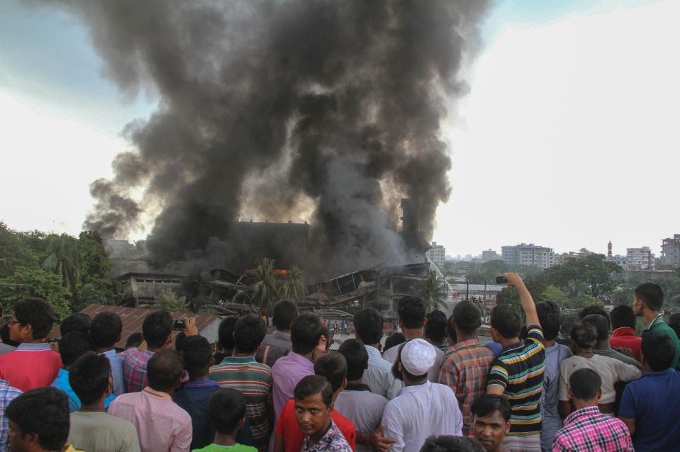  Smoke and flames billow from a burning garment factory in Tongi