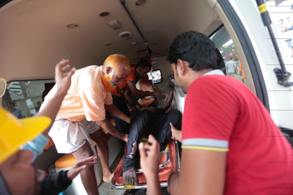  An injured person rescued from a fire is taken into an ambulance